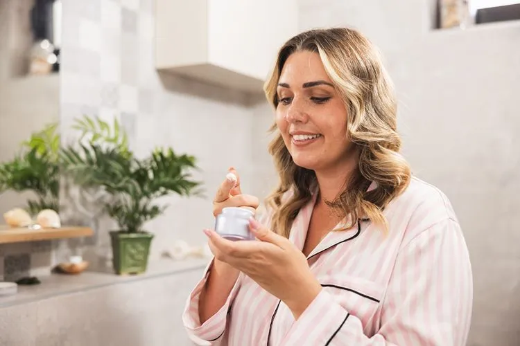 Woman applying moisturiser - best skincare brands Ireland
