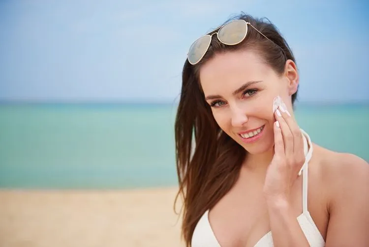 Woman applying ISDIN SPF sunscreen